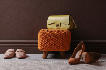 Stylish pouf with bag and shoes at home