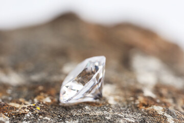 One beautiful shiny diamond on stone surface, closeup