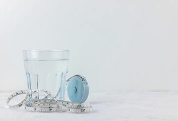 Healthy lifestyle concept. glass of water, tape measure