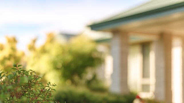 Soft focus on a modern suburban homes exterior with blurred greenery