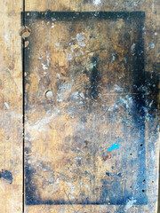 Wooden bench covered in layers of various paint marks in an arts studio