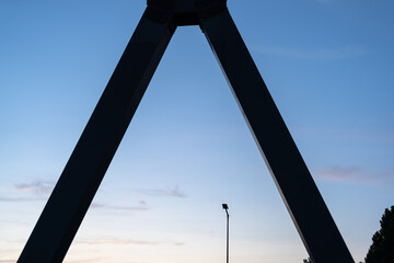  Urban skyline at dusk framed by a bridge structure.