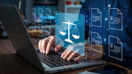 Legal professional using laptop with justice scales and digital document icons overlayed