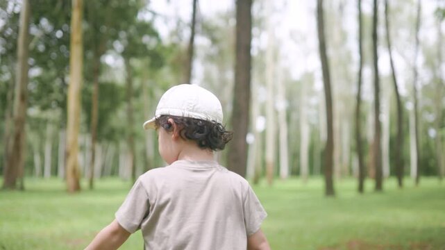 Carefree child walking in a forest, holding a stick and enjoying the calm of nature. Captures the essence of childhood freedom, curiosity, and a deep connection with the natural world.