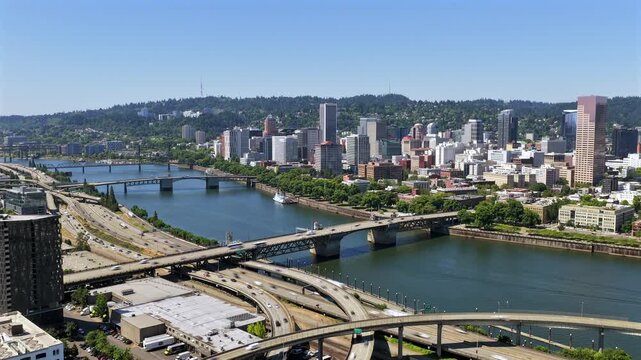 Portland Oregon - Aerial Timelapse Approach Over Highways & Bridges Towards Downtown on Sunny Day with Boat Passing By