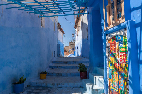 Colorful Tile Adorns Wall in Blue Painted Stone Walkway in Chefchaouen Morocco