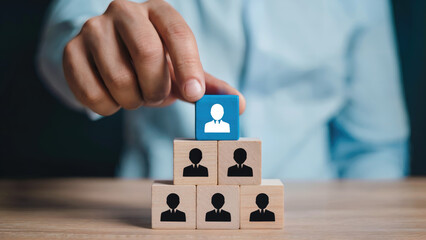 Hand places leadership block atop team hierarchy pyramid