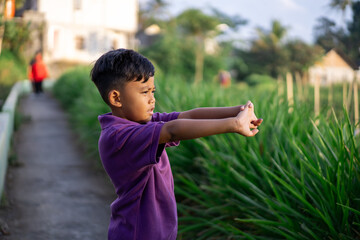 son doing physical workout and warming up before jogging. outdoor sport