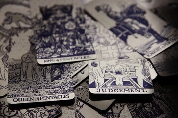 Mystical atmosphere captured through a detailed tarot card arrangement on a textured surface. Rich symbolism and traditional esoteric themes evoke intuition, divination, and spiritual insight. Ideal f