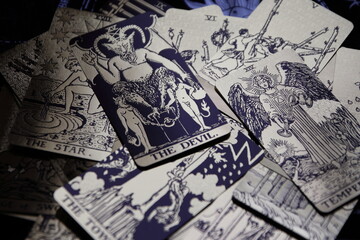 Mystical atmosphere captured through a detailed tarot card arrangement on a textured surface. Rich symbolism and traditional esoteric themes evoke intuition, divination, and spiritual insight. Ideal f