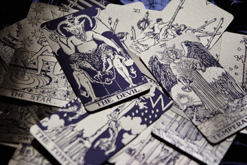 Mystical atmosphere captured through a detailed tarot card arrangement on a textured surface. Rich symbolism and traditional esoteric themes evoke intuition, divination, and spiritual insight. Ideal f