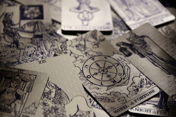 Mystical atmosphere captured through a detailed tarot card arrangement on a textured surface. Rich symbolism and traditional esoteric themes evoke intuition, divination, and spiritual insight. Ideal f