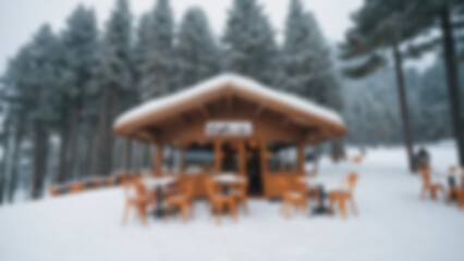 Blurry photo of a cafe located on a snowy mountain with a view of high mountains, pine trees surrounded by snow, blurry wallpaper.