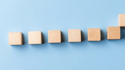 The wooden blocks are arranged in the form of stairs on the blue ground, the steps to business success, the concept of success