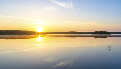 Fototapeta premium Peaceful sunrise over expansive lake with mirror like water surface reflecting soft early light and distant tree line under clear sky creating calm and serene atmosphere