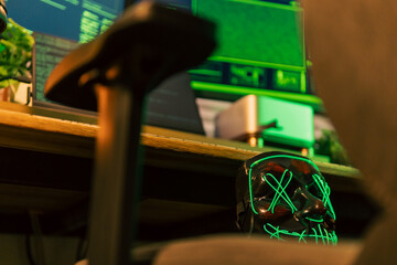 In a dimly lit cyber lair, a glowing hacker mask watches over a desk as encrypted code streams...