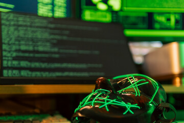 In a dimly lit cyber lair, a glowing hacker mask watches over a desk as encrypted code streams...
