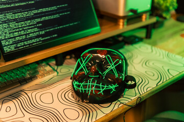 In a dimly lit cyber lair, a glowing hacker mask watches over a desk as encrypted code streams...