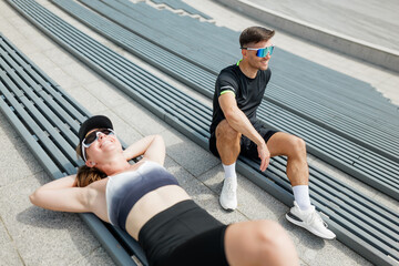 Active individuals relax and unwind after workout session in a modern outdoor space