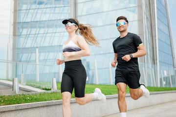 Modern athletes enjoy a sunny morning jog in an urban environment