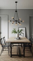 A dining room featuring a wooden table with black metal legs, surrounded by black chairs and illuminated by a modern chandelier.