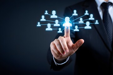 Businessman touching a glowing network of people icons symbolizing connection and teamwork