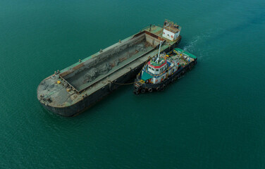 Aerial Shot of Tugboat Pushing Loaded Barge at Sea