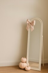 vertical halloween interior in coquette style with full mirror, pumpkins and satin bow, soft pastel tones and clean empty space on upper wall for text, concept of editorial layout, seasonal home styli