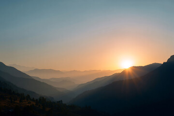 Layers of Mountains in a Colorful Sunrise Mist