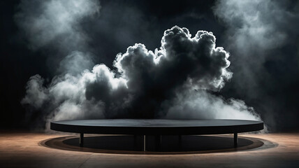 A two-tiered, black circular platform with a cloud or smoke effect filling the backdrop and the upper part of the stage. This composition creates the impression of a presentation or performance.