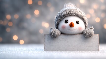 Obraz premium Cute snowman with a gray hat peeking over a blank sign board on snowy winter blurred background, banner with copy space