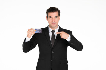 Confident man in formal wear points to a credit card, inviting viewers to consider their financial options or a specific product. studio on white background.