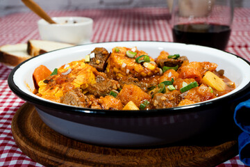 Fototapeta premium Delicious beef stew called carbonada with potatoes, corn, and carrots simmering in a rustic bowl