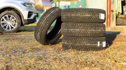 Winter tires near the garage. Safety concept for winter driving. Purchase and purchase of new tires...