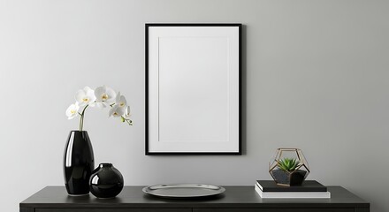 Modern minimalist home interior: black frame mockup, white orchid in vase, geometric terrarium, silver tray, dark console table.