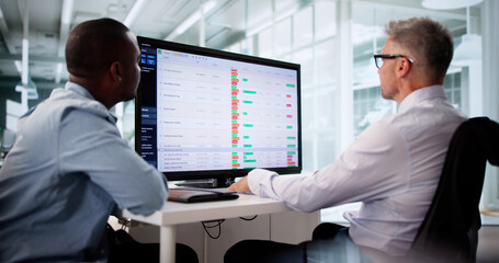 Focused Business Team Analyzing Reports