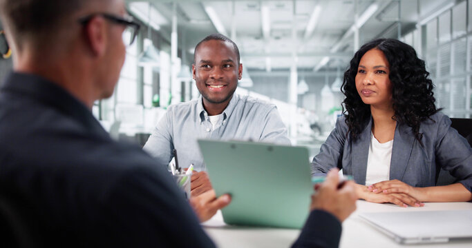 Diverse Realtor Advisor Guides Happy Couple Through Real Estate - Powered by Adobe