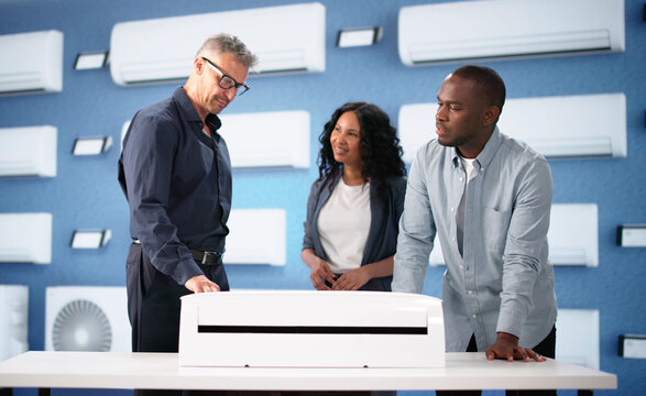 Smiling Couple Consults With Technician