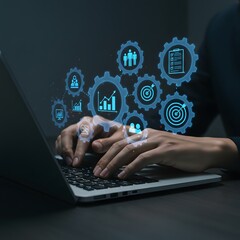 Person typing on laptop with digital gears and icons representing business processes