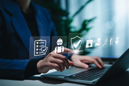 Work safety and compliance concept. A person using a laptop with digital icons representing work safety, compliance, regulations, and professional standards, symbolizing secure workplace practices.