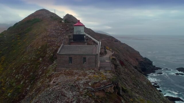 Aerial view of the Point Sur Lighthouse, a California State Historic Landmark, located on the central coast of Big Sur, California, USA. The lighthouse warns ships of the rocky coastline.