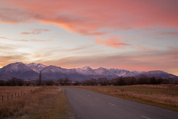 The sun sets over New Zealand's Southern Alps. Photographed from a road near Twizel in the South Island