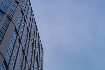 Exterior of modern multi-storey skyscraper building in central business district of city against...
