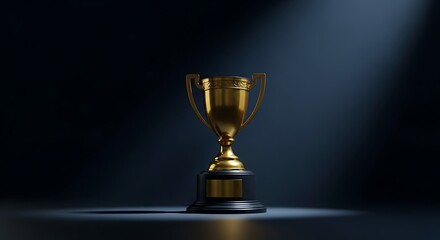 Golden trophy illuminated by spotlight on dark background