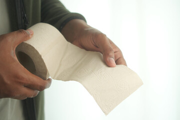 Holding a roll of paper towel in a well-lit room