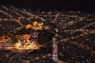 Seda Tibetan Buddhist academy illuminated at night in the monastic town of Tibet