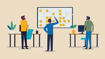 Three people in an office looking at a whiteboard with sticky notes discussing project planning