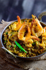 Bengali-style cabbage dry fry with prawn served in a small serving kadai – bandhakopi chingri, traditional dry curry, Indian stir-fried cabbage with shrimp, rustic Bengali home-cooked dish
