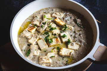 North Indian-style safed paneer – creamy white paneer curry in cashew and milk-based gravy, traditional Indian vegetarian dish, rich mild curry, royal-style shahi paneer variant, top view
