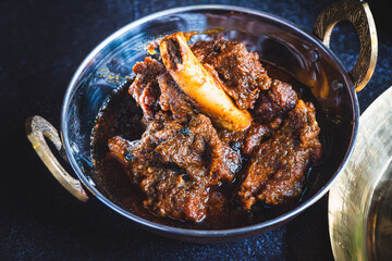 Traditional Bengali-style mutton kosha &ndash; spicy slow-cooked Indian goat curry, kosha mangsho, authentic Bengali mutton dish, homestyle non-veg curry, festive meat preparation, rustic top view